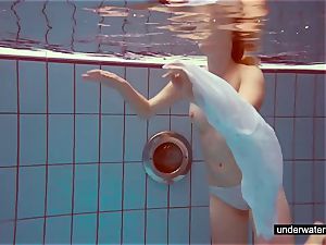 adorable redhead plays bare underwater